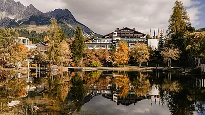 herbsturlaub-uebergossene-alm-resort-salzburg-005.jpg Ansicht Hotel vom Almsee im Herbst